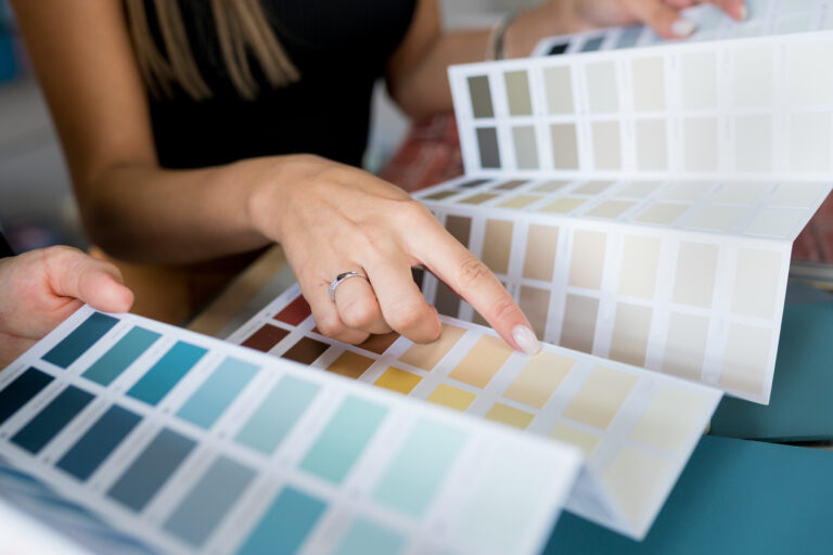 Women choosing paint colours from samples. Choose wall paint from Moonlight Painters in St. Thomas, Ontario.
